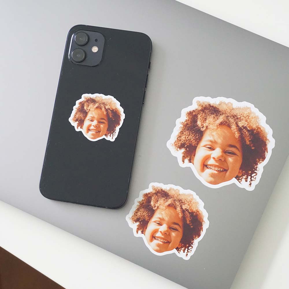 face as a sticker stuck on a laptop